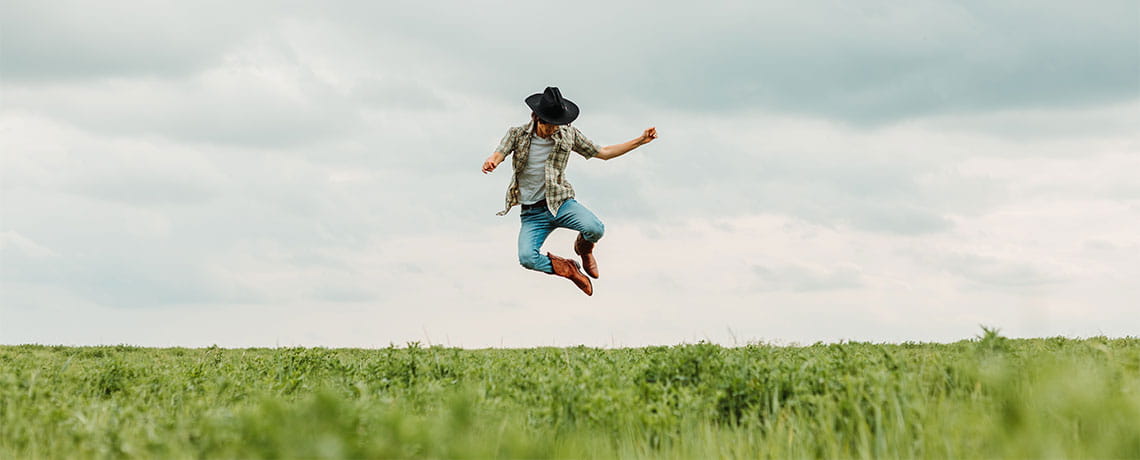 farmer jumping in field