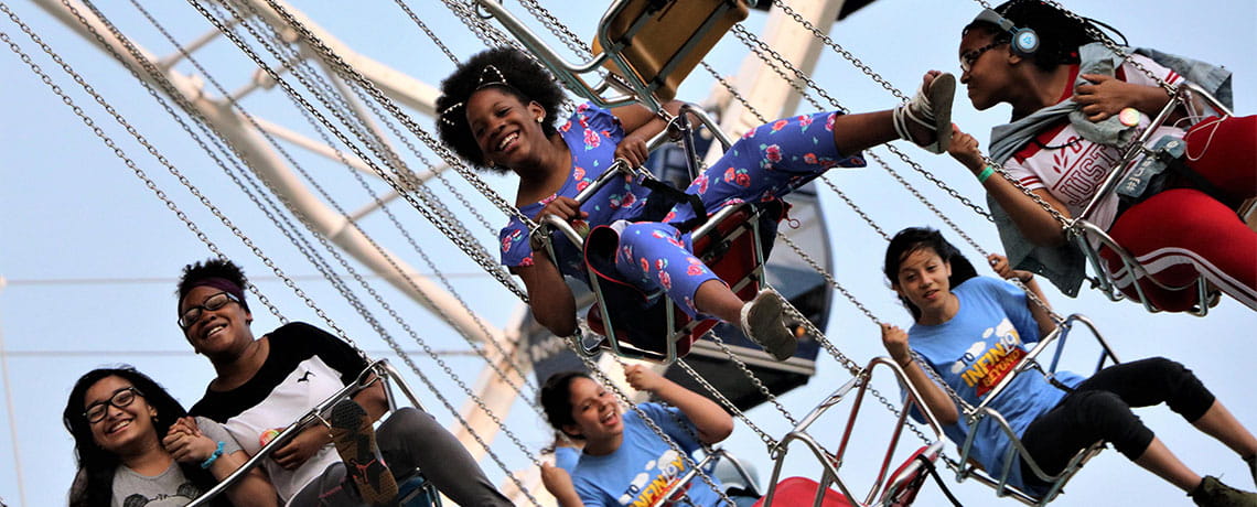 People on amusement park ride at Chicago boardwalk