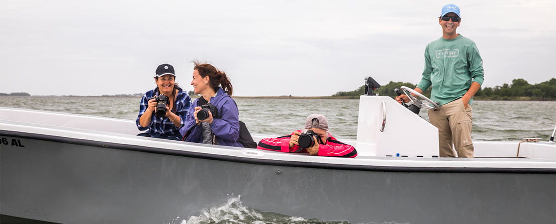 Group of people on a boat, taking pictures