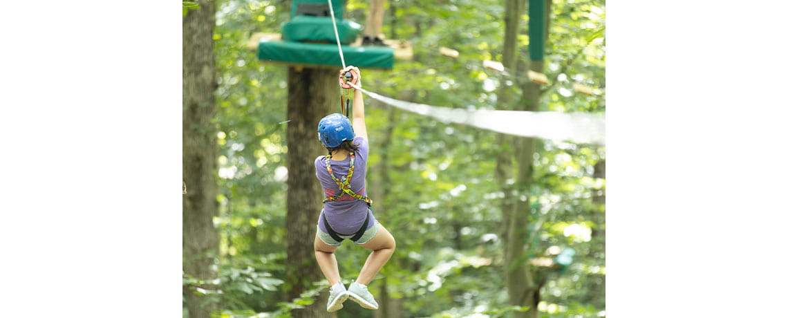 Child zip-lining at Varginia's Treetop Quest