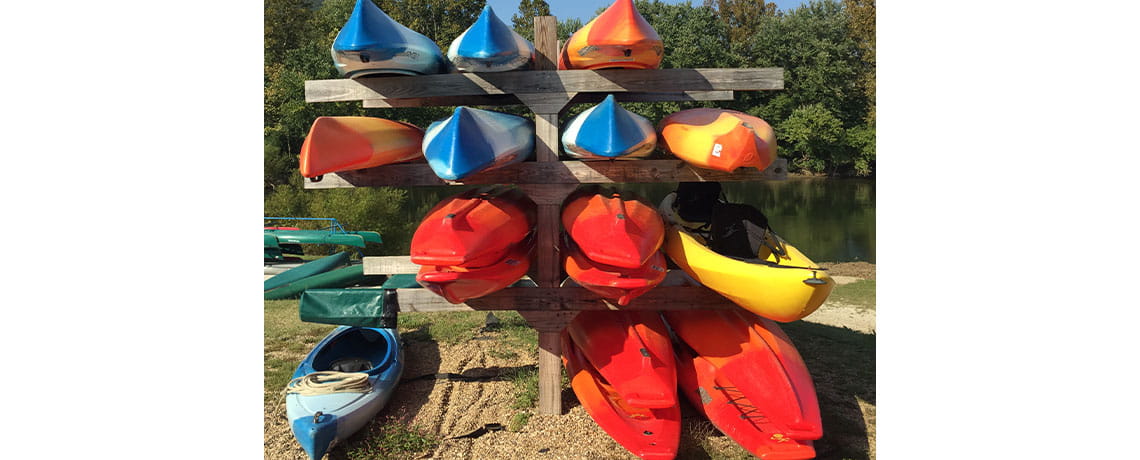 Stack of colorful kayaks
