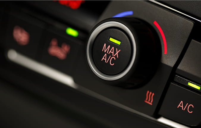 AC button on car dashboard