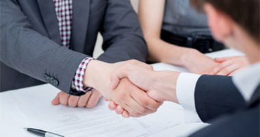 Man and Woman shaking hands at the end of a business deal