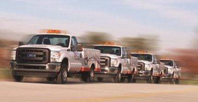 AAA fleet trucks on a highway