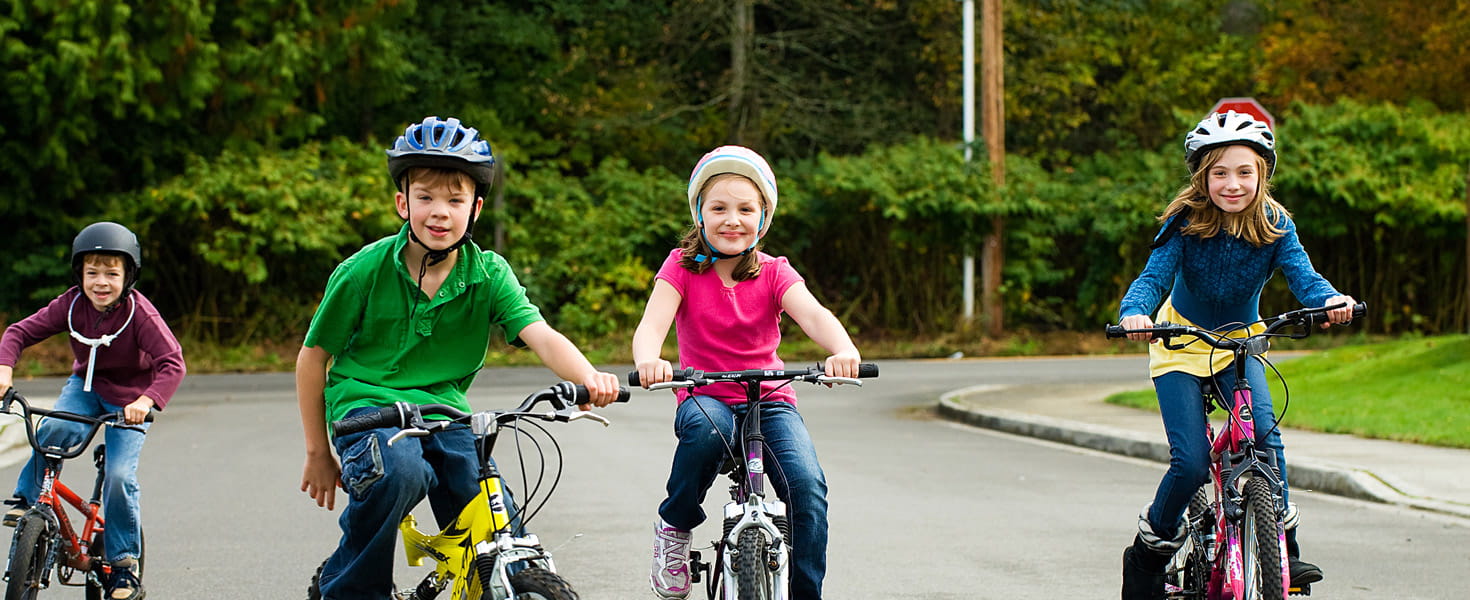 Group of kids in helmets on their bicycles