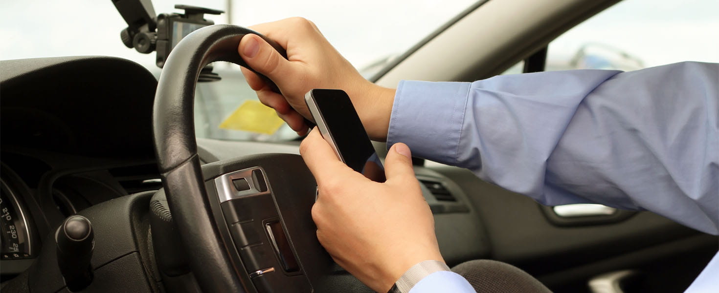 Businessman Using Mobile Smart Phone While Driving