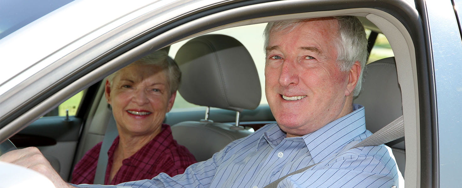 Senior Citizen Couple Driving Their Car