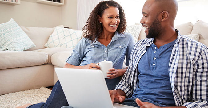 man and woman reviewing policy on their laptop