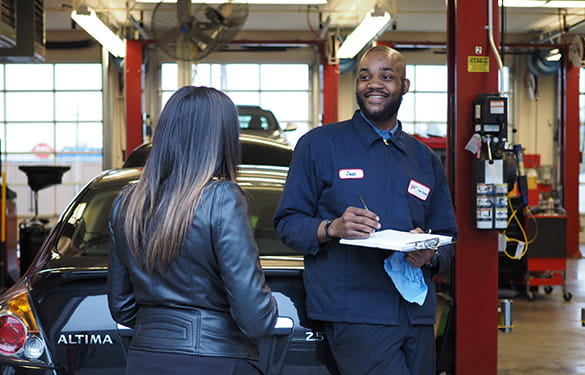 mechanic at a AAA shop talking to a member about service