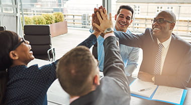 group in a meeting high fiving