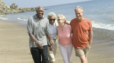 Senior Citizen Couples walk on the Beach