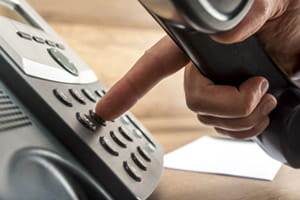 male hand dialing a business phone