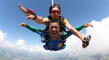 Two people skydiving in the air