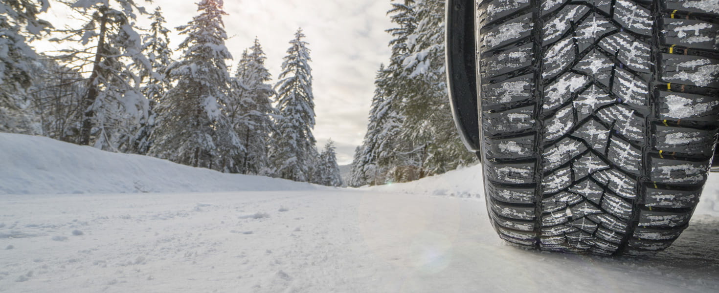 Image of car tire on snowy road