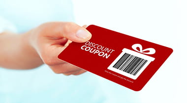 Hand holding a red card that says discounts