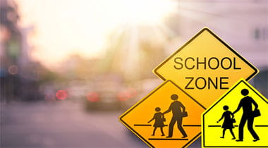 School zone and pedestrian walking signs.