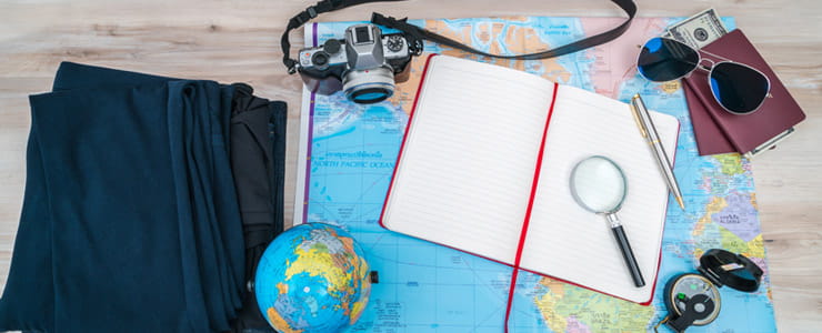passport and other travel related items on a desk