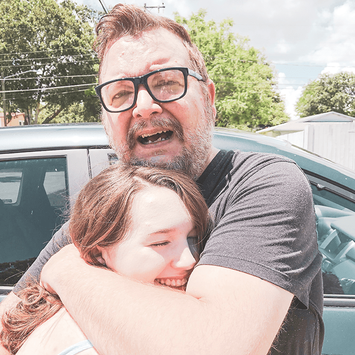father hugging daughter