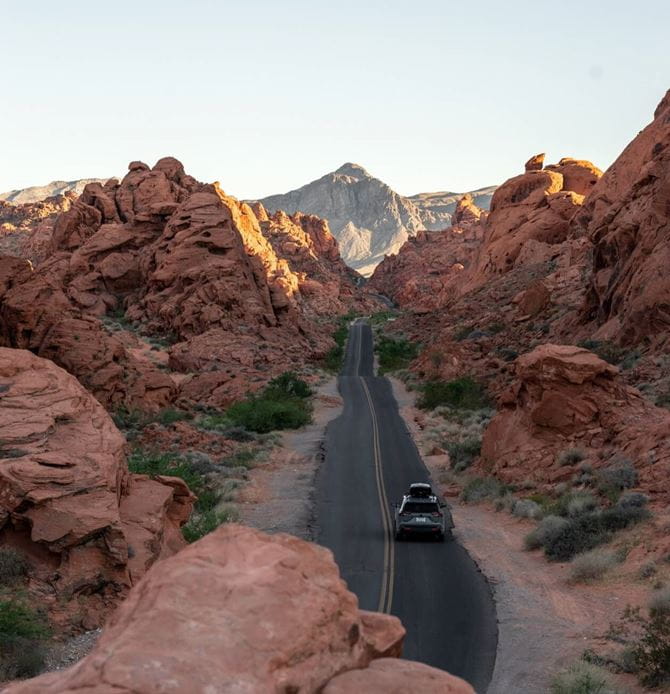 Car traveling down road through the desert