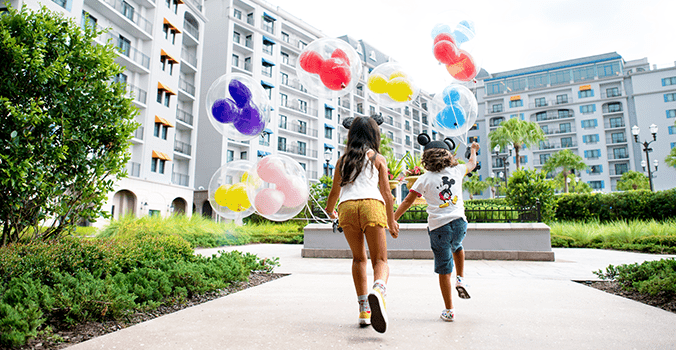 Two kids with balloons at Disney World