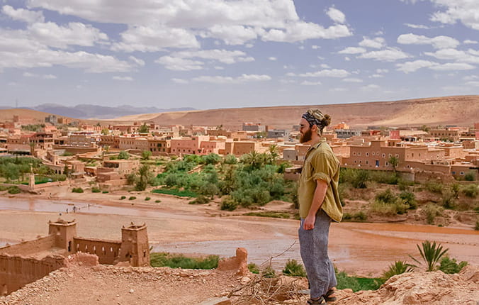 Tourist overlooking Moroccan buildings in the Desert.