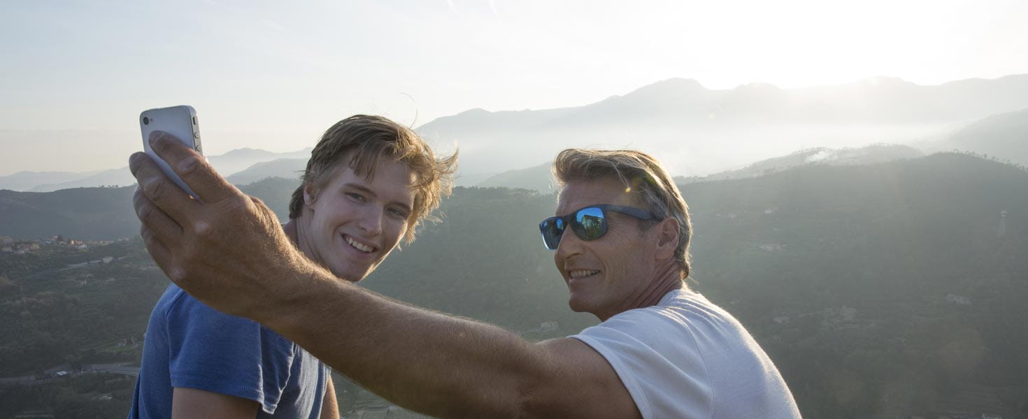 Dad and son taking selfie on vacation