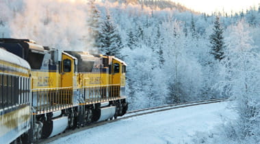 Train moving through snowy scenery