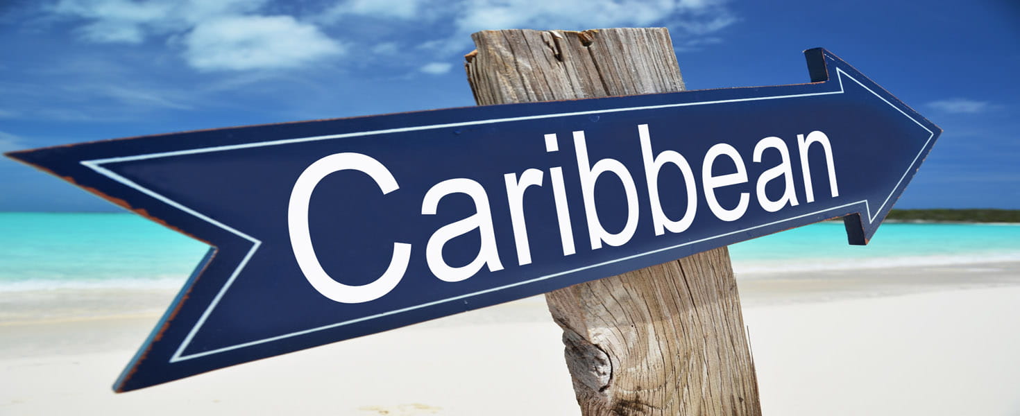 Sign in the Sand pointing to the Caribbean