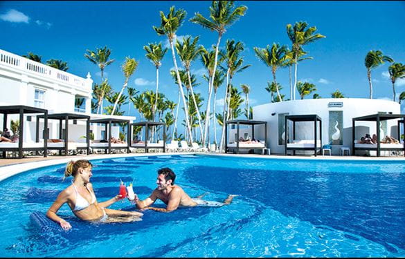 Couple vacationing in pool at Hotel Riu Palace Bavaro