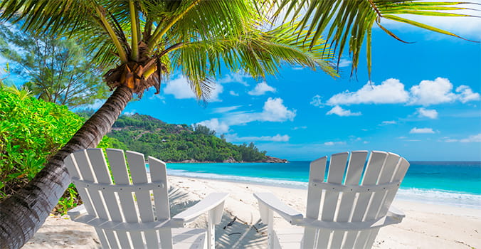 AAA Cruise destinations - deck chairs on caribbean beach