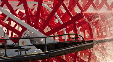 Movement of water by riverboat paddle wheel