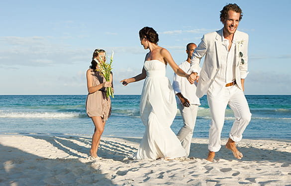 Married couple on beach with friends
