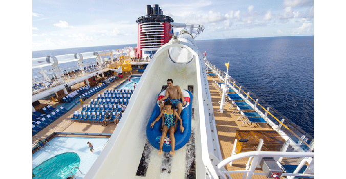Cruisers on the Aqua slide aboard a Disney Cruise