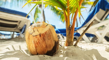 Coconut cocktail on beach.