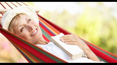 Senior Woman Relaxing In Hammock