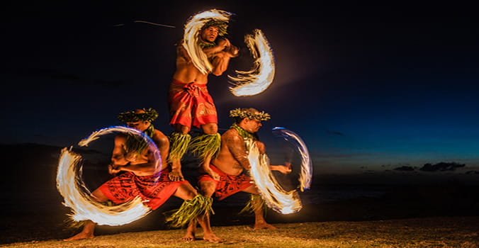 Traditional Hawaiian flame throwers dancing on the beach