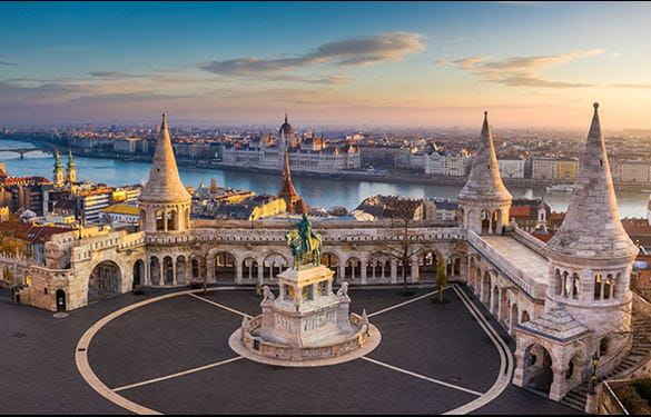 Budapest, Hungary - Aerial view of the famous Fisherman's Bastion at sunset with Parliament building at background. 