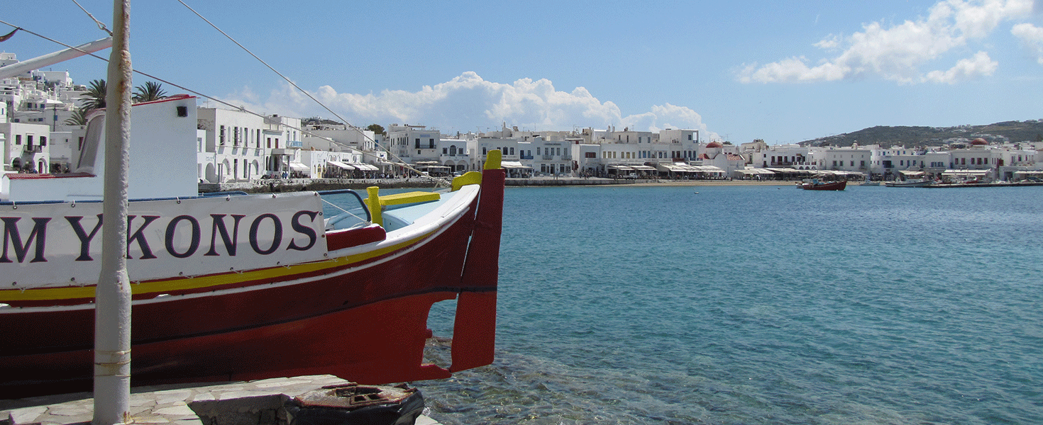 A boat floating in the water by Mykonos