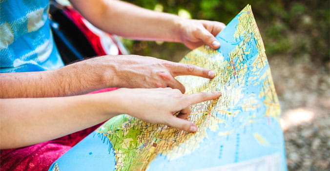 Closeup of hands of travelers looking at a map