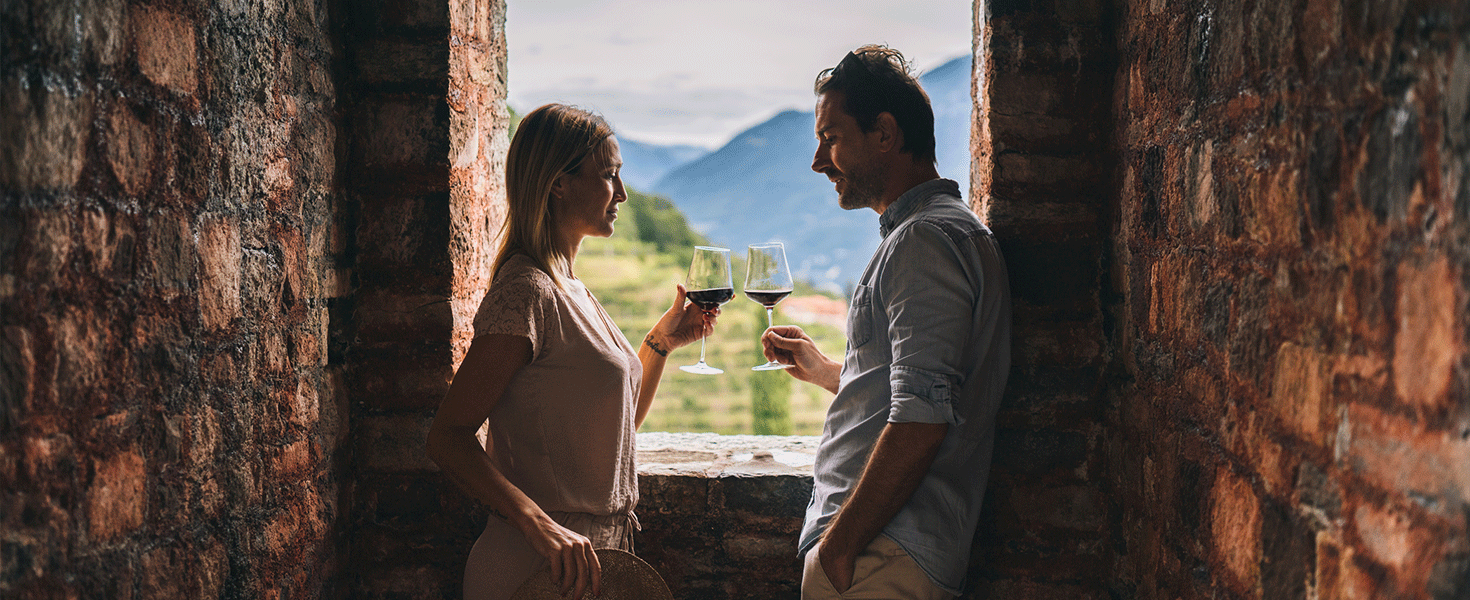 Couple at Italy vineyard drinking wine