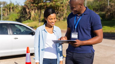 Driver instructor talking to student learner before taking driving test