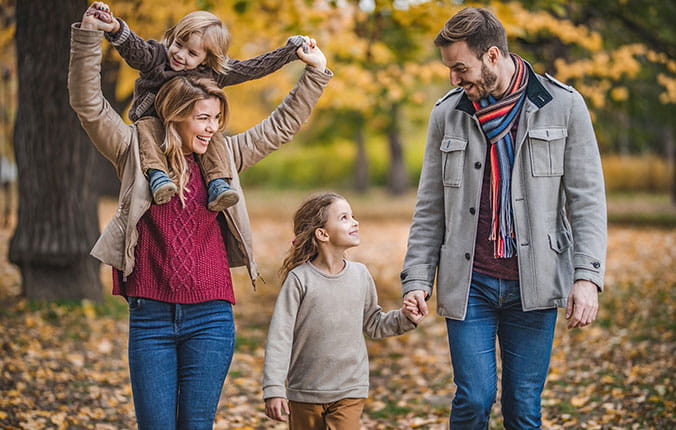 Family walking outdoors in the fall