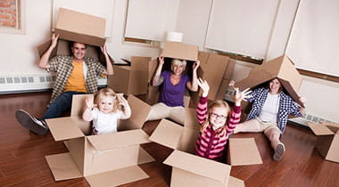 A funny image of a family popping out of moving boxes. 