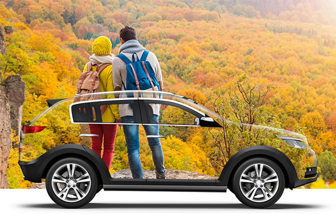 Couple looks at fall foliage, overlay with transparent rental car