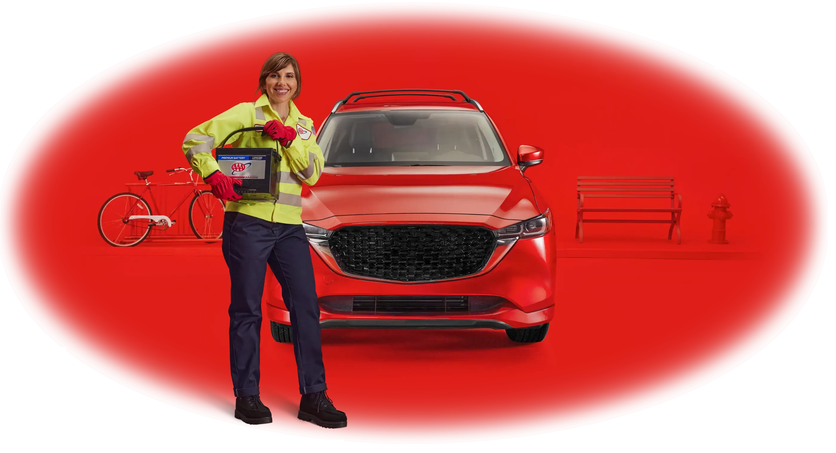 Smiling woman in yellow safety vest holding a AAA car battery, standing in front of a red SUV with a bicycle and bench in the background, all on a red backdrop
