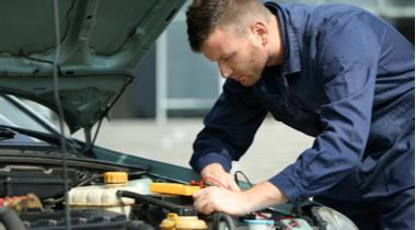 Mechanic repairing car engine