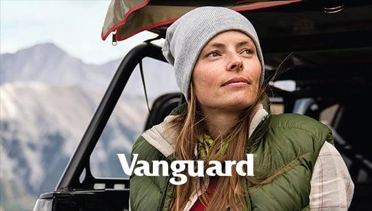 Close up of woman in winter hat sitting on back of car