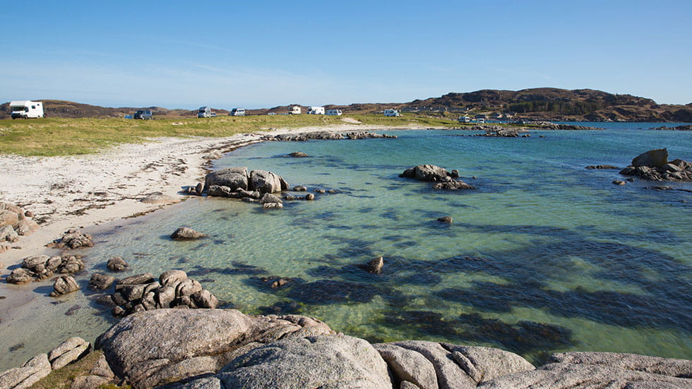 Fidden beach Isle of Mull Scotland uk Inner Hebrides near to Iona and Fionnphort. One of the best natural Scottish beaches with clear blue sea and white sand and popular with motorhomes and campervans. Photo courtesy of acceleratorhams/iStock.com