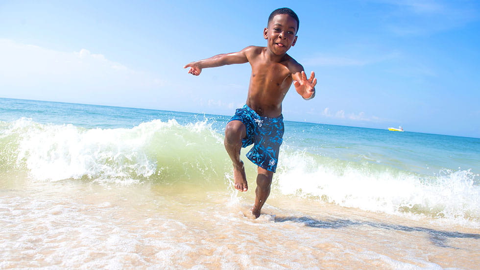 Kid Playing at Gulf State Park Beach. Phot courtesy of Gulf Shores Orange Beach Tourism