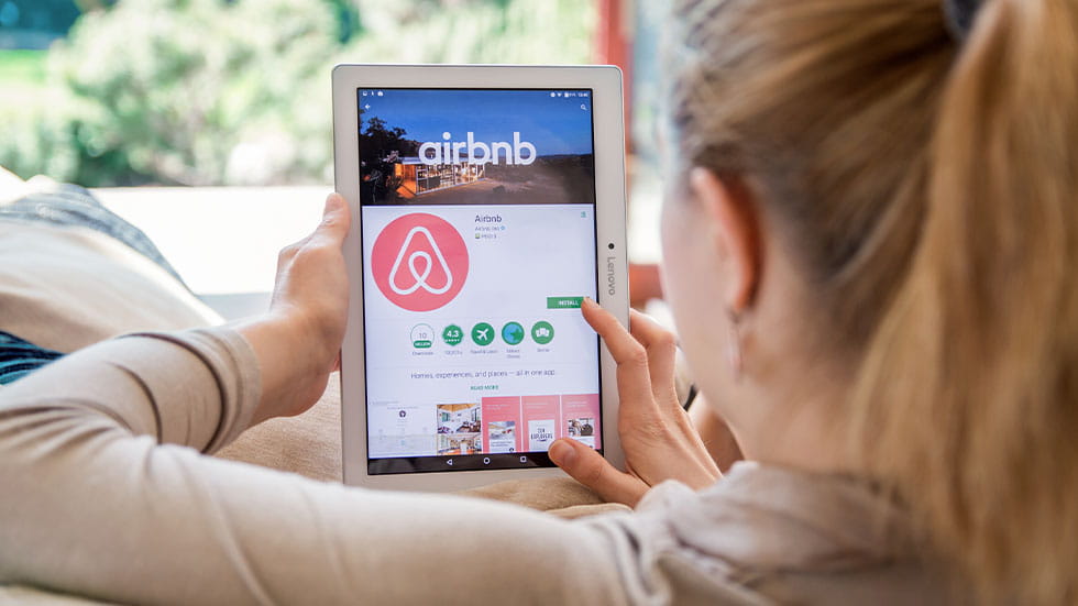 woman using Airbnb app